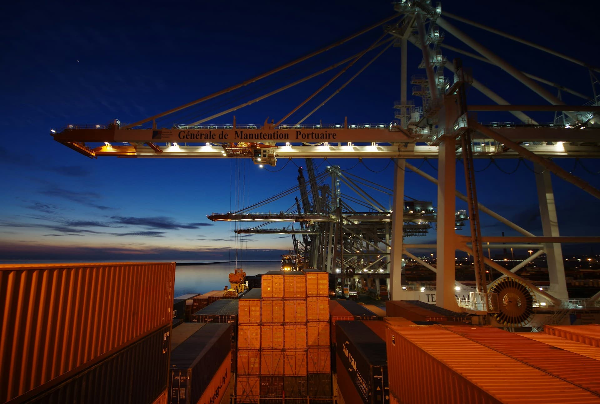Cargo ship docked at night — Photo by Bob Brewer on Unsplash